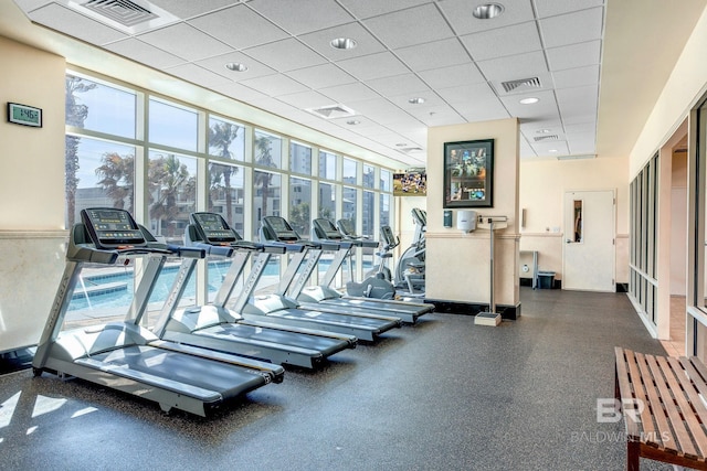 gym featuring plenty of natural light, visible vents, and a drop ceiling