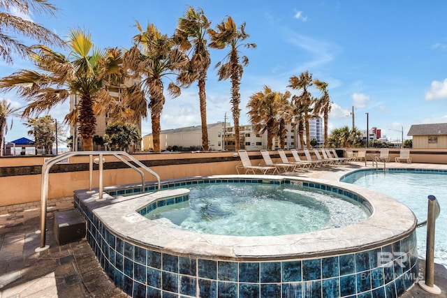 view of swimming pool featuring a patio area and a community hot tub