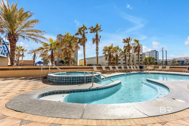 view of pool with a pool with connected hot tub and a patio