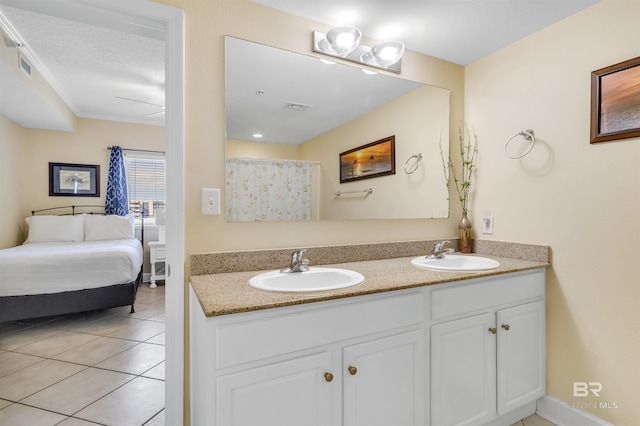 bathroom featuring tile patterned flooring, visible vents, a sink, and double vanity