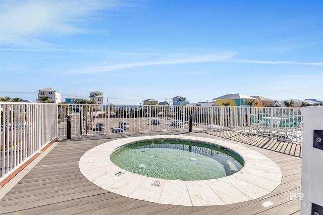 view of swimming pool featuring a community hot tub