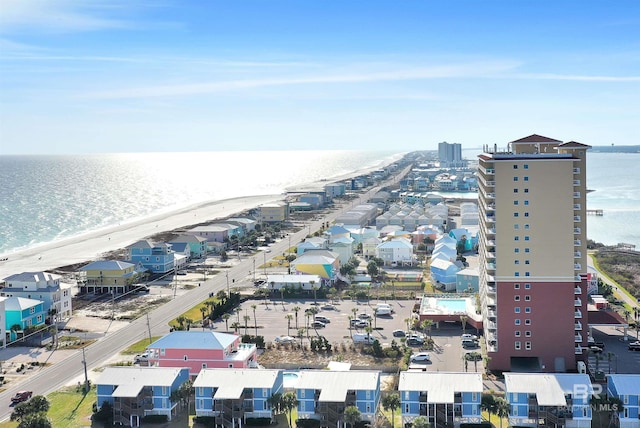 aerial view with a water view and a beach view