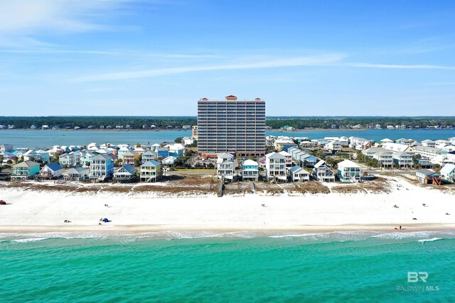 bird's eye view with a water view and a beach view