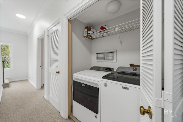 laundry room featuring washer and clothes dryer, crown molding, baseboards, and light colored carpet
