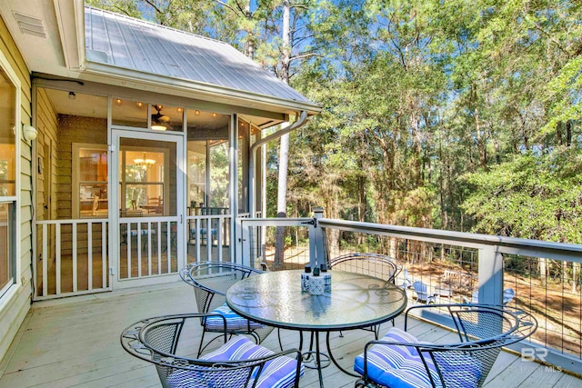 wooden deck featuring a sunroom