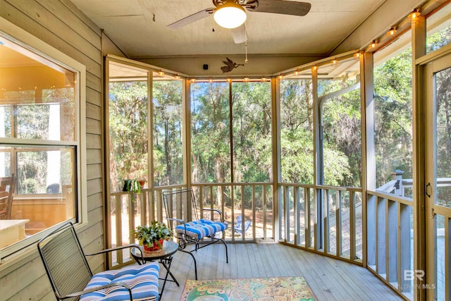 unfurnished sunroom with plenty of natural light and ceiling fan