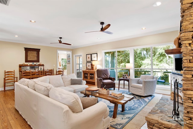 living room with light hardwood / wood-style flooring, a wealth of natural light, ornamental molding, and ceiling fan