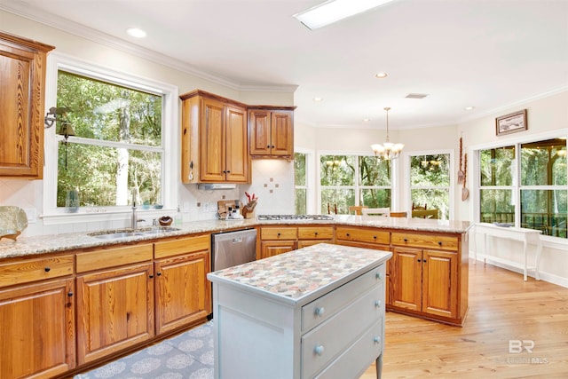 kitchen with backsplash, a wealth of natural light, and light hardwood / wood-style flooring