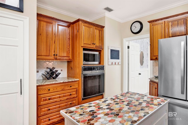 kitchen with light stone counters, ornamental molding, appliances with stainless steel finishes, and tasteful backsplash