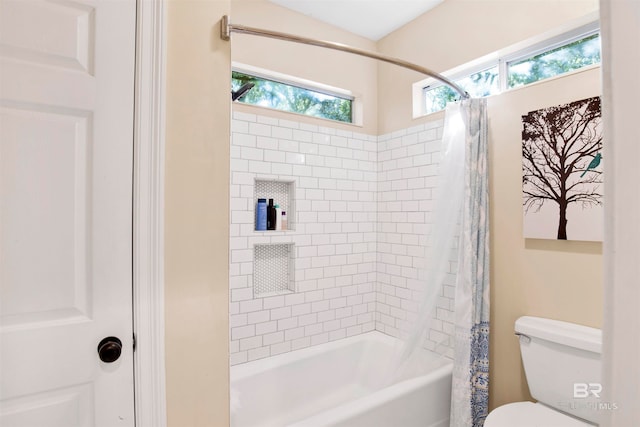 bathroom featuring toilet and shower / tub combo with curtain