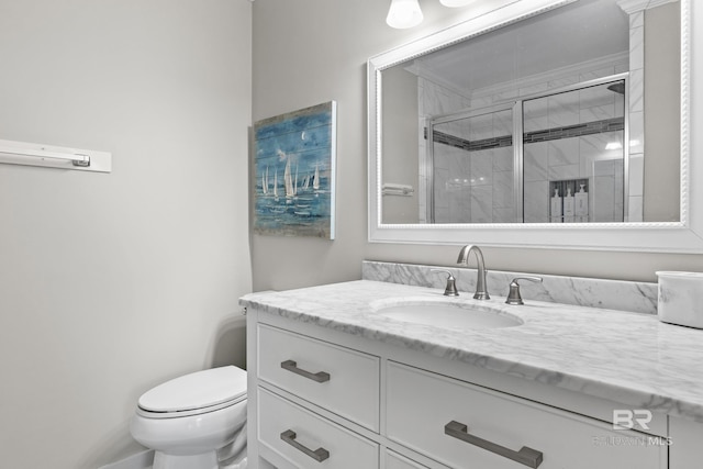 bathroom featuring vanity, toilet, and walk in shower