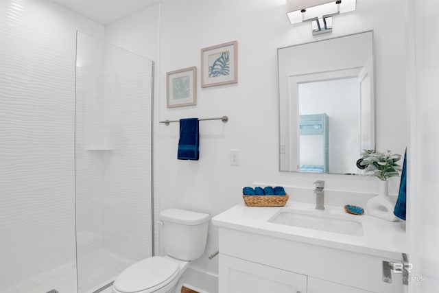 bathroom featuring an enclosed shower, vanity, and toilet