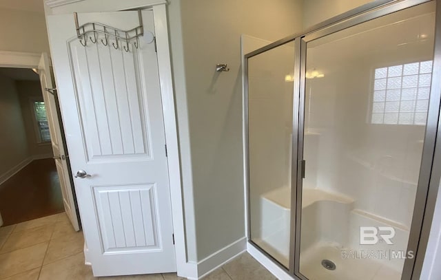 bathroom with walk in shower and tile patterned floors