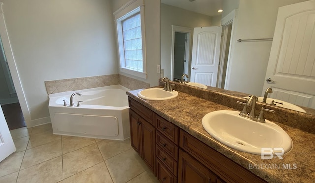 bathroom featuring vanity, a tub to relax in, and tile patterned floors