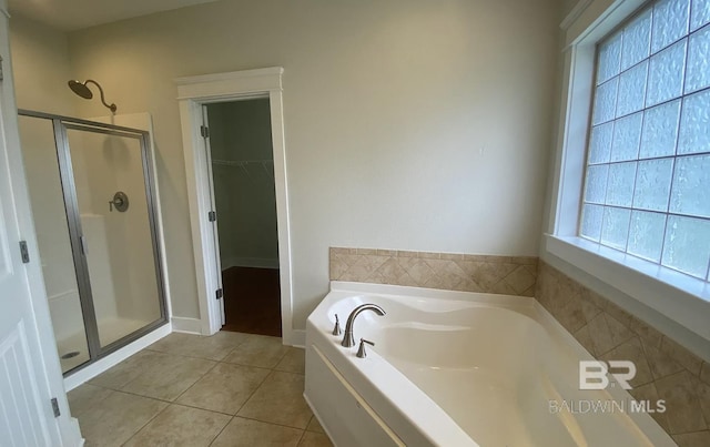 bathroom with separate shower and tub and tile patterned floors