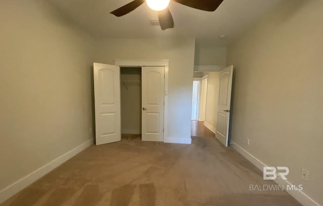 unfurnished bedroom with carpet flooring, ceiling fan, and a closet