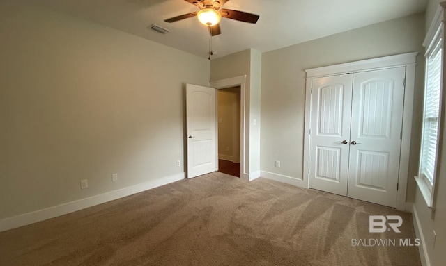 unfurnished bedroom featuring carpet flooring, ceiling fan, and a closet