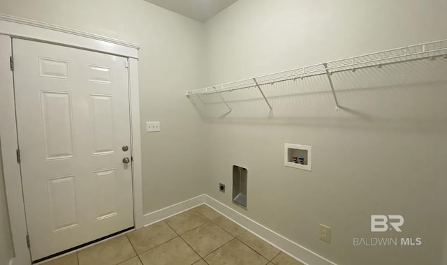 clothes washing area with hookup for a washing machine, electric dryer hookup, and light tile patterned floors