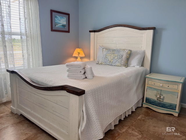 bedroom featuring dark tile flooring