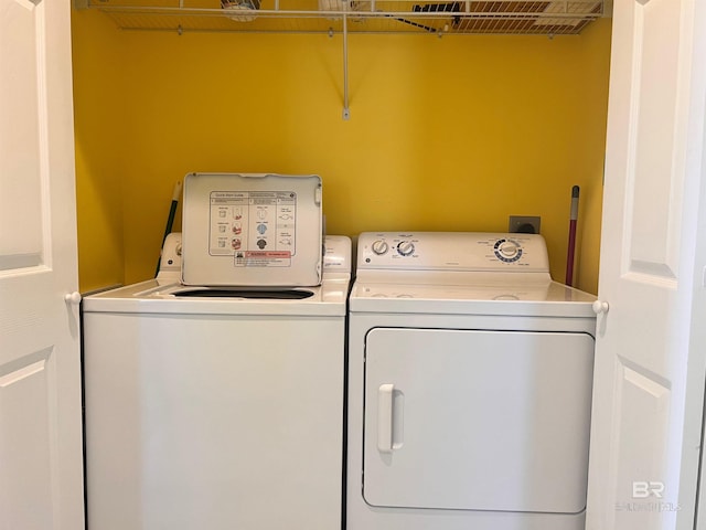 clothes washing area with electric dryer hookup and washer and dryer