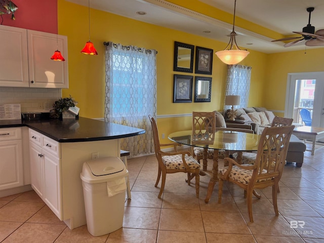 interior space featuring tasteful backsplash, white cabinetry, light tile floors, ceiling fan, and hanging light fixtures