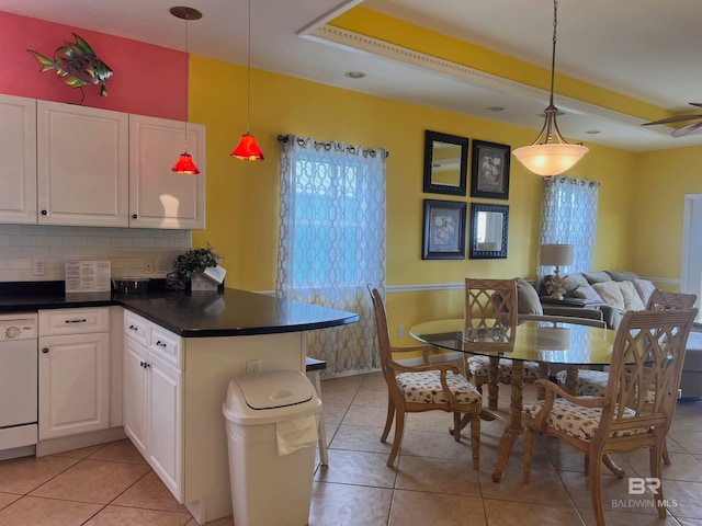 kitchen featuring white cabinetry, decorative light fixtures, backsplash, ceiling fan, and light tile floors
