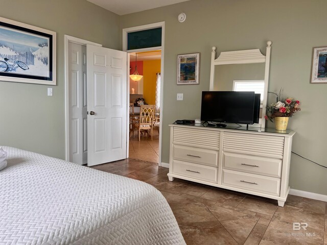 bedroom featuring dark tile floors