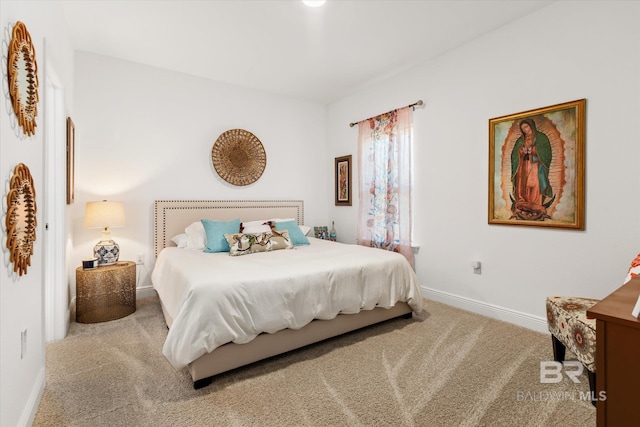 carpeted bedroom featuring baseboards