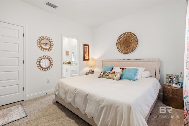 carpeted bedroom featuring baseboards, visible vents, and connected bathroom