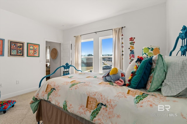 bedroom featuring carpet floors and baseboards