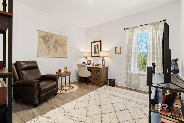 office area featuring baseboards and wood finished floors