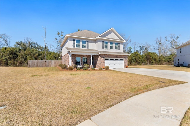 view of front facade with driveway, brick siding, an attached garage, fence, and a front yard