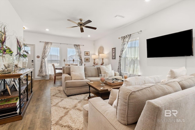 living area featuring a wealth of natural light, ceiling fan, wood finished floors, and recessed lighting