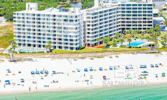 bird's eye view with a water view and a beach view