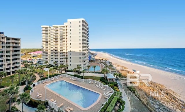 view of pool featuring a view of the beach and a water view