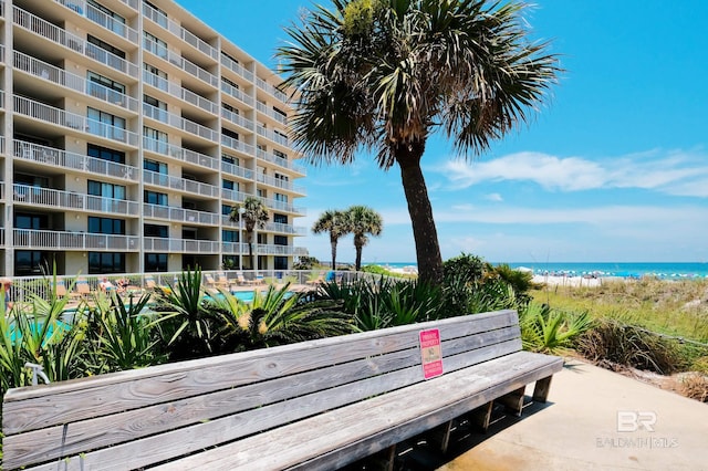 view of home's community featuring a water view and a beach view