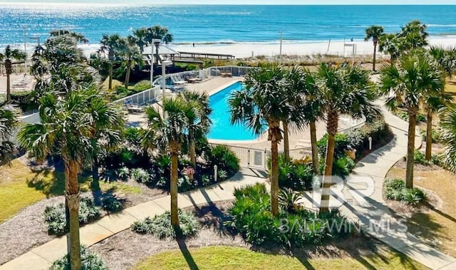 birds eye view of property featuring a water view and a beach view