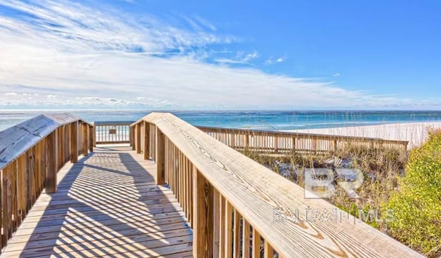 view of property's community featuring a beach view and a water view