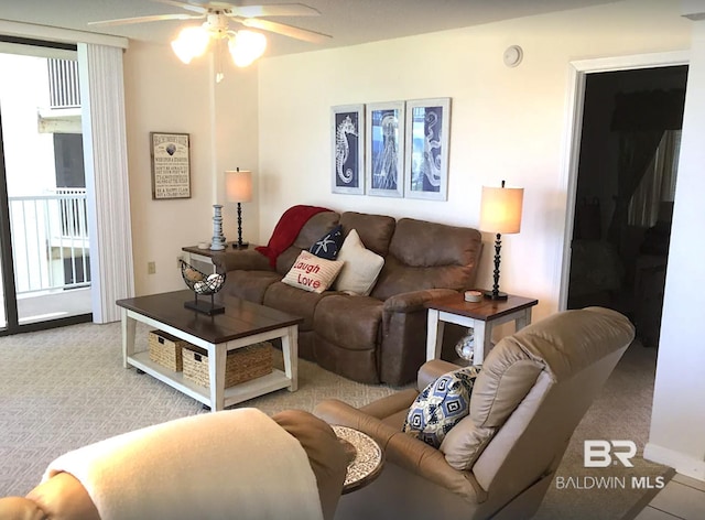 living area featuring a ceiling fan and light colored carpet