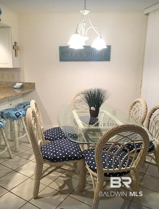 dining room with light tile patterned floors and a chandelier