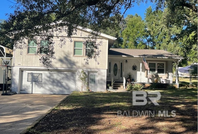 split level home featuring a porch and a garage