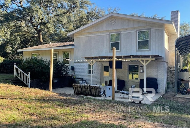 rear view of property with outdoor lounge area and a patio