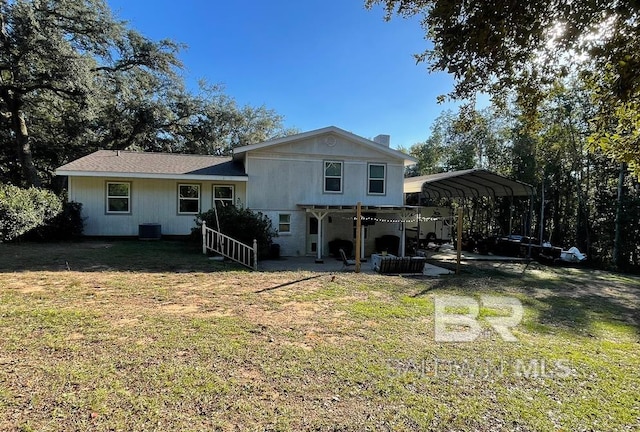 back of house featuring a lawn and a carport