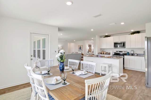 dining area with light hardwood / wood-style floors