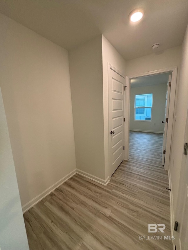 corridor with light hardwood / wood-style floors