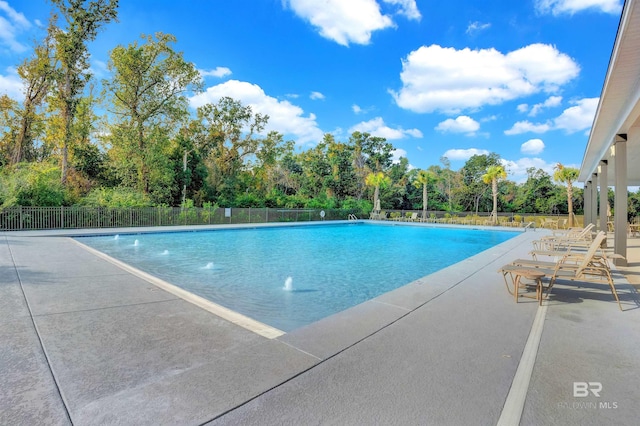 view of pool featuring pool water feature and a patio