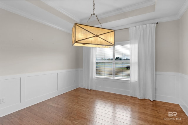 empty room featuring ornamental molding and hardwood / wood-style floors