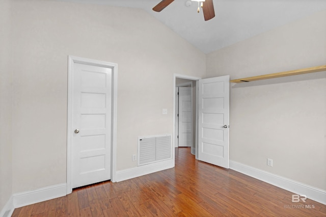 unfurnished bedroom with hardwood / wood-style flooring, vaulted ceiling, and ceiling fan