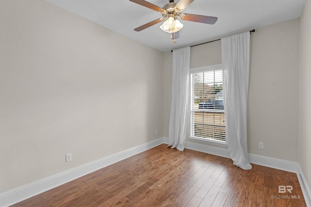 empty room with hardwood / wood-style floors and ceiling fan