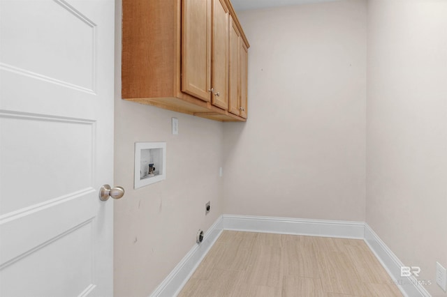 clothes washing area featuring cabinets, electric dryer hookup, and washer hookup